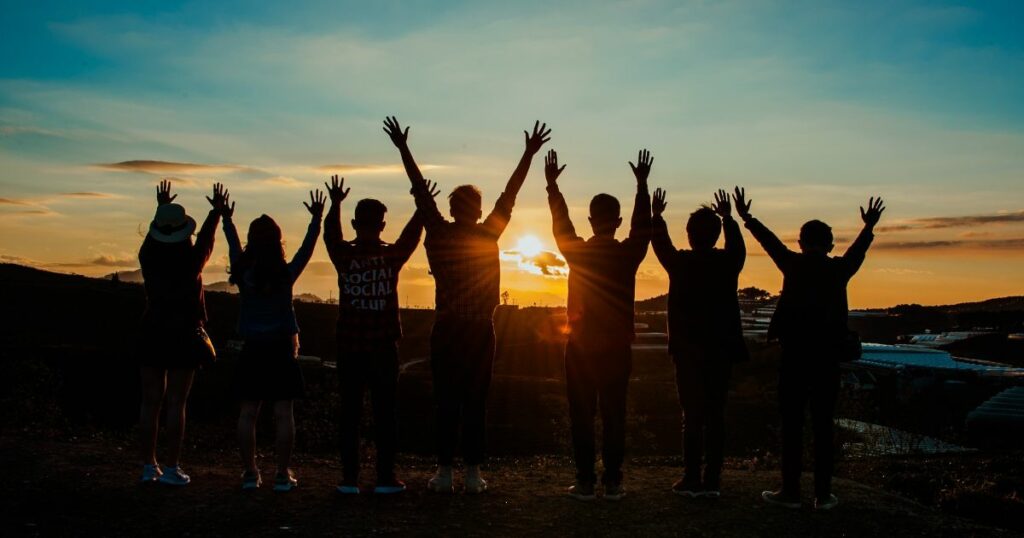 Friends with their hands in the air