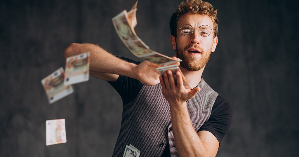 A man 'making it rain' with money bills